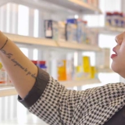 Cassandra, a woman with long, black hair is buying pharmacy products