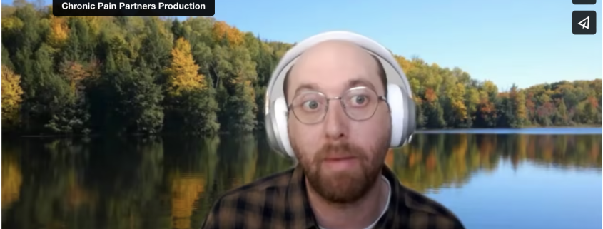 Elan Schneider, a bald man, wearing white headphones and glasses.