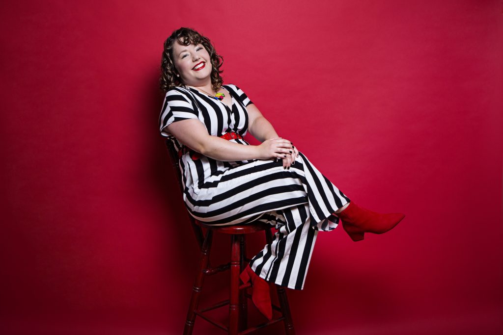 Here I am in my black and white stripey jumpsuit which looks a bit like beetlejuice. With my red boots on matching the red background. I'm sitting down and looking very professional indeed (makes a change)