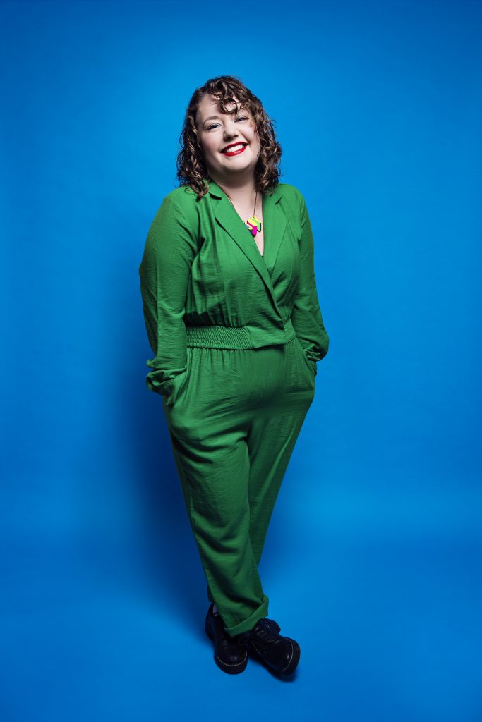 Here I am in my bright green jumpsuit and my favourite Morag Myerscough "Joy" necklace posing nice and politely against a lovely blue background.