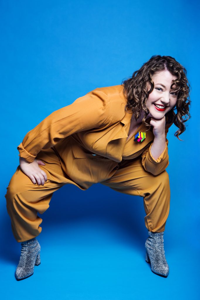 Here I am squatting wide in my mustard yellow vintage 80's suit. I am leaning on my left leg, and I've got a cheeky green - as all squat and leaners should. My shoes are shiny and silver, and my necklace says "Joy".