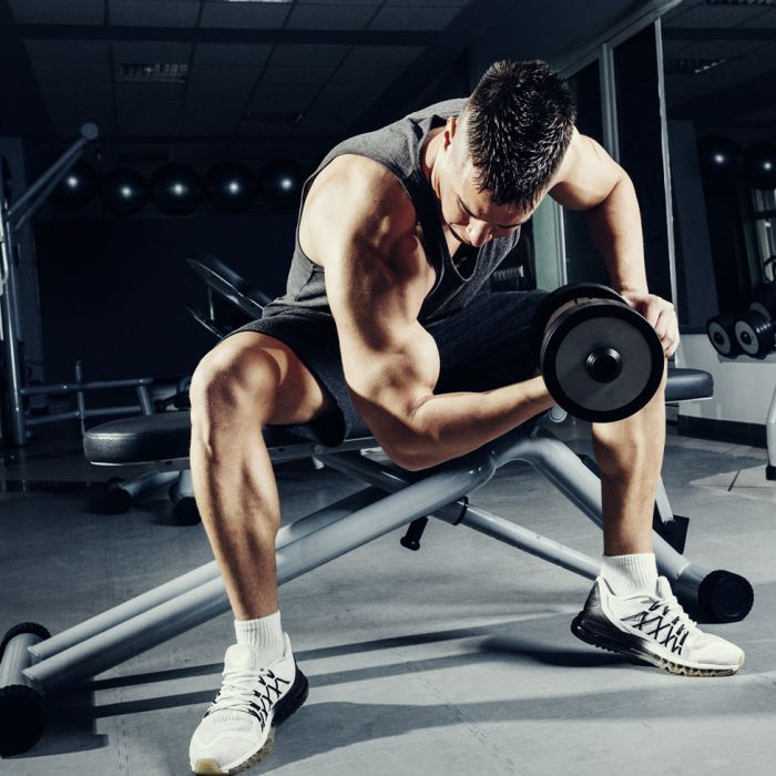 Man met een dumbbell aan het trainen in een sportschool