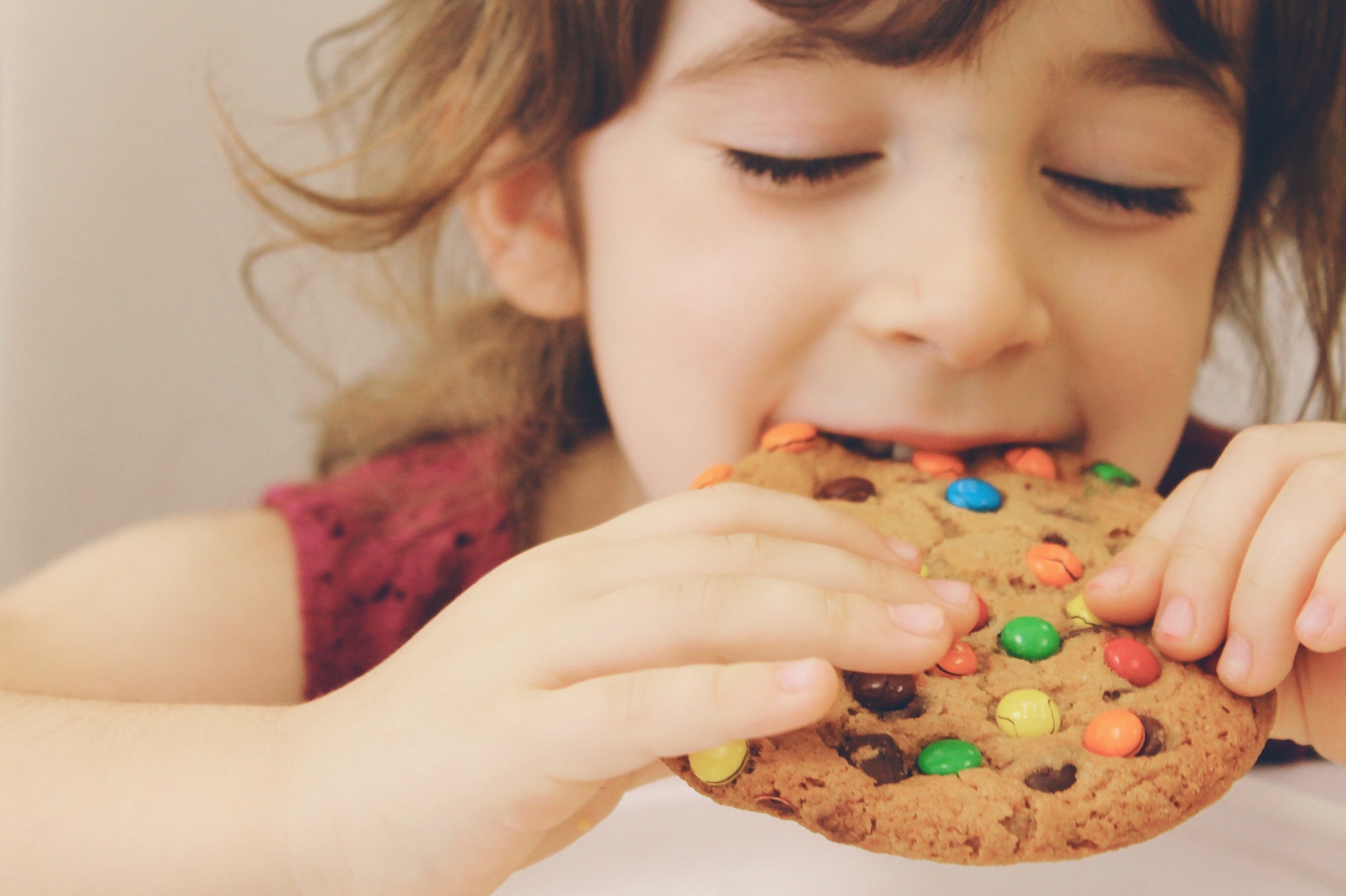 Girl eating cookie.
