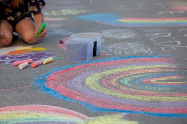 Chalk. Draw a rainbow on the pavement with colored crayons. Outdoor games for children.