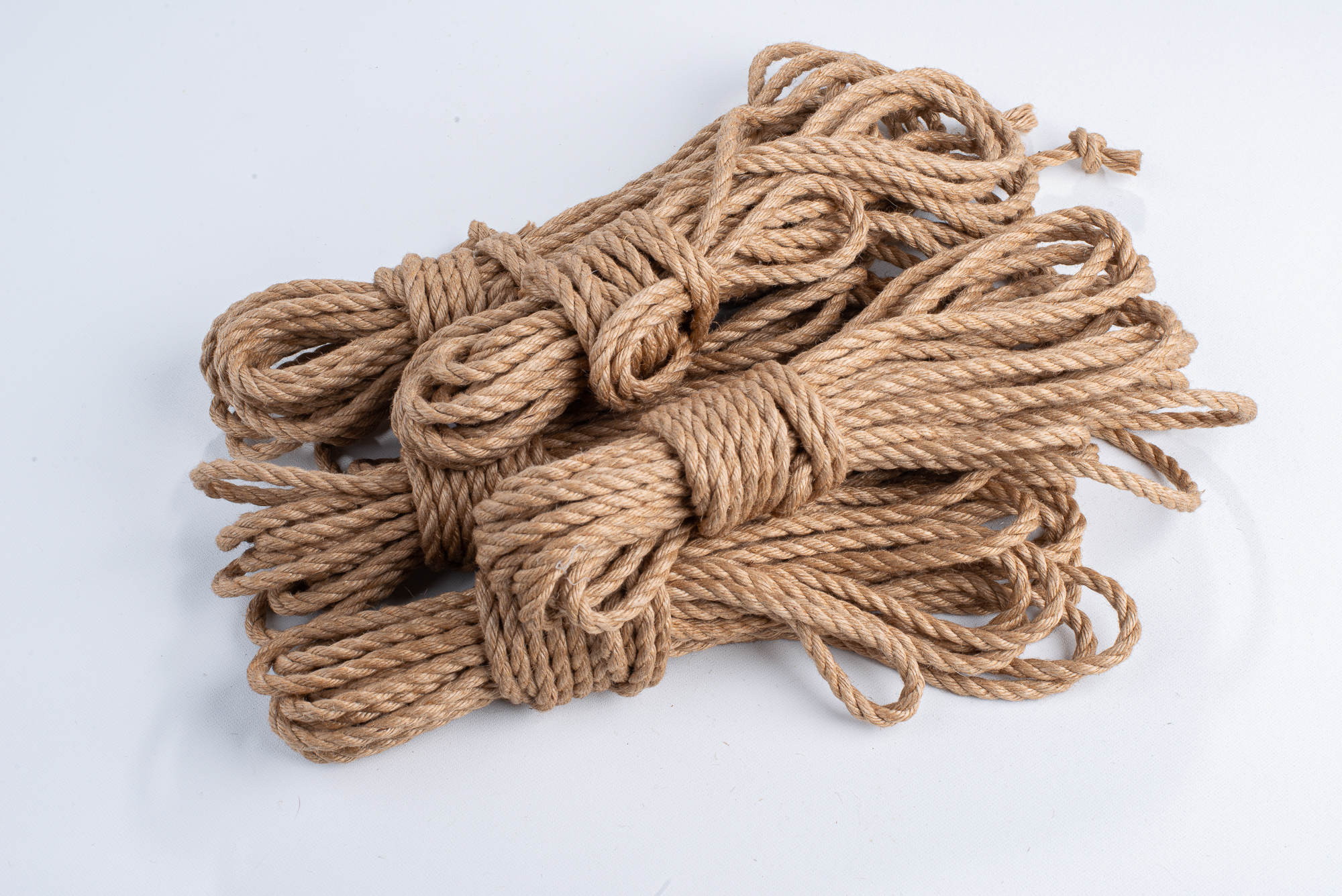 a bundle of jute rope on a white surface