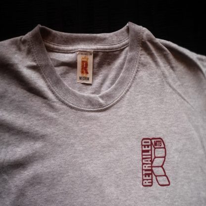 RED RETRAILED TAG ON GREY TSHIRT