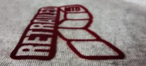 RED RETRAILED TAG ON GREY TSHIRT DETAIL