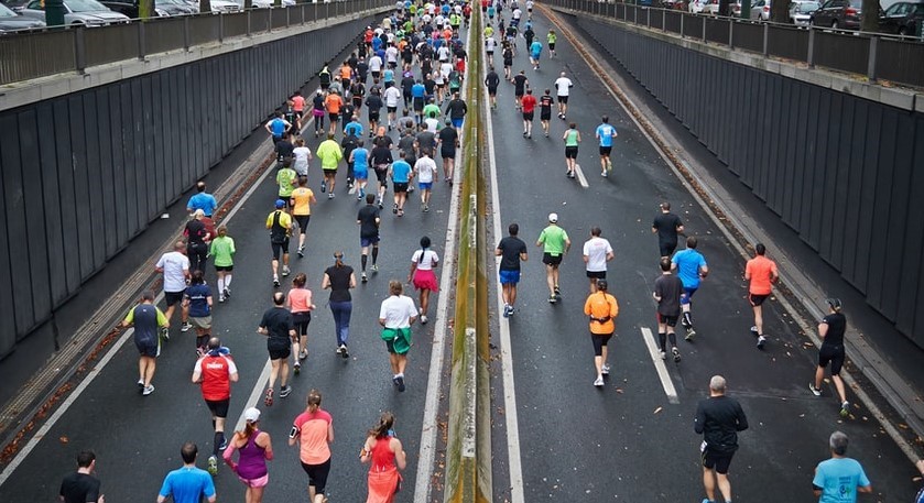 A group of people getting exercise running down a highway