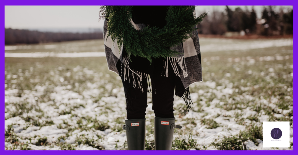 There's no death in the countryside here - just a woman wearing wellies and holding a green foliage wreath