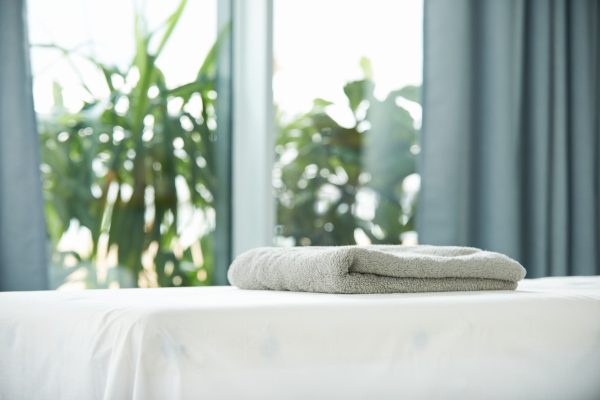 Shot of a tranquil room with towels on a massage bed during the day