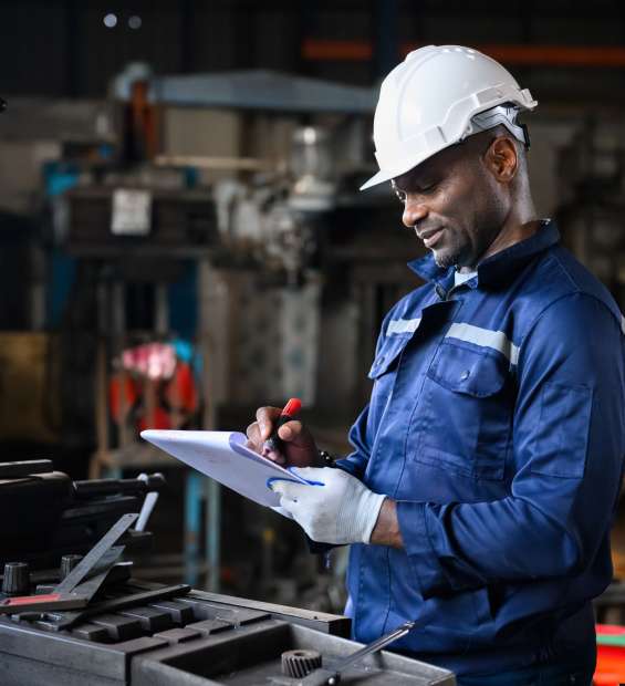 Professional male industrial worker in white hard hat working at manufacturing Professional male industrial worker in white hard hat working at manufacturing plant, Industrial engineer portrait