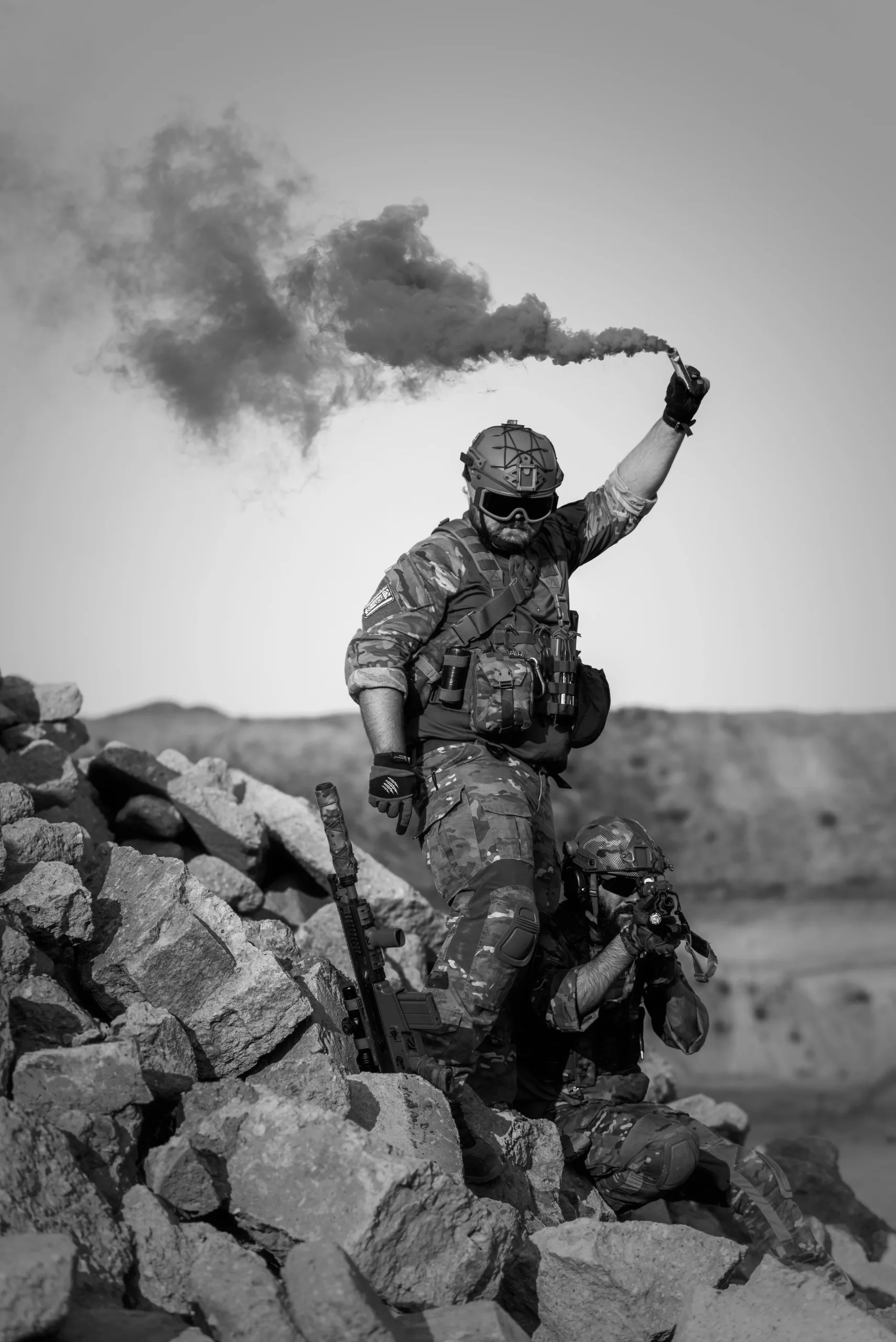 Soldiers at war throwing a smoke grenade.