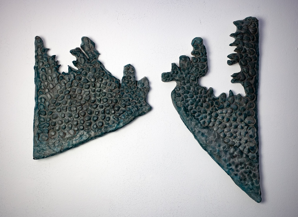 Wall sculptures made from Jesmonite and broze showing silouettes of roads