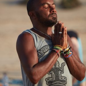 Banana meditating on the beach during a yoga retreat