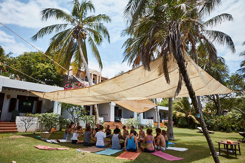 Participants have a yoga session in Lamu