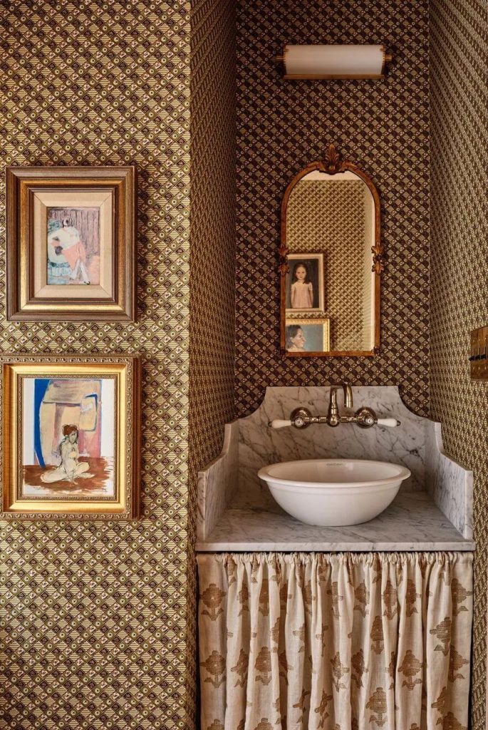 designed by Katie Rosenfeld, with Setting Plaster by Farrow & Ball, creates a harmonious balance in a bathroom adorned with Michael S. Smith wallpaper.