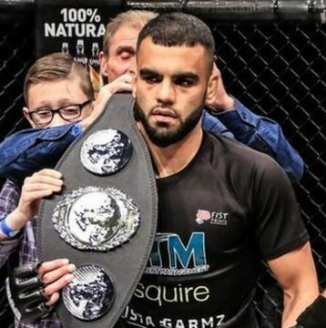 Faisal Malik, The Owner of LegendsMMA. Black Belt in Brazilian Jiu Jitsu Holding His Championship Belt