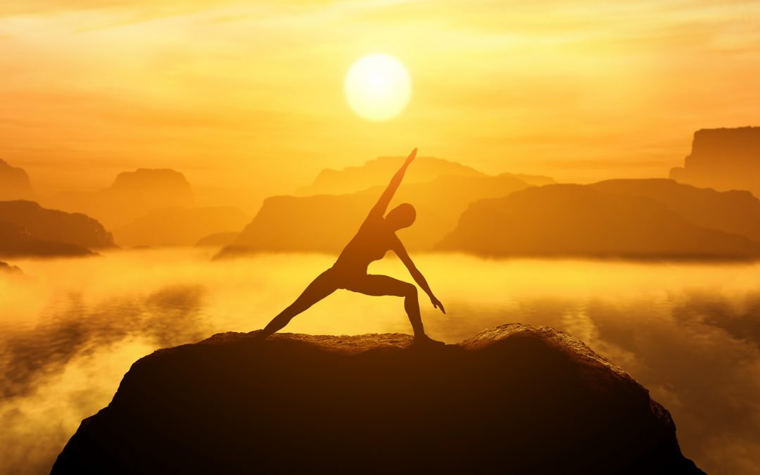 Woman standing in side angle yoga position, meditating on the to