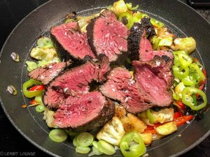 Beef tenderloin with mixed vegetables in a pan