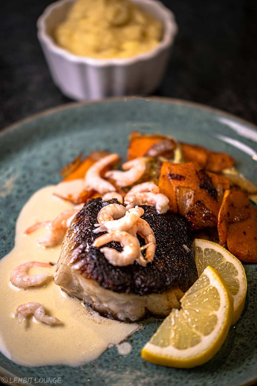 Fried cod with Sandefjord sauce Norwegian vegetables shrimps