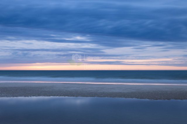 When the sea recedes at low tide pools are formed on the beach of Middelkerke, Flanders, Belgium