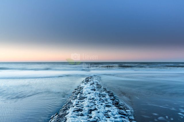 A breakwater reaching out in the sea at Middelkerke, Flanders, Belgium