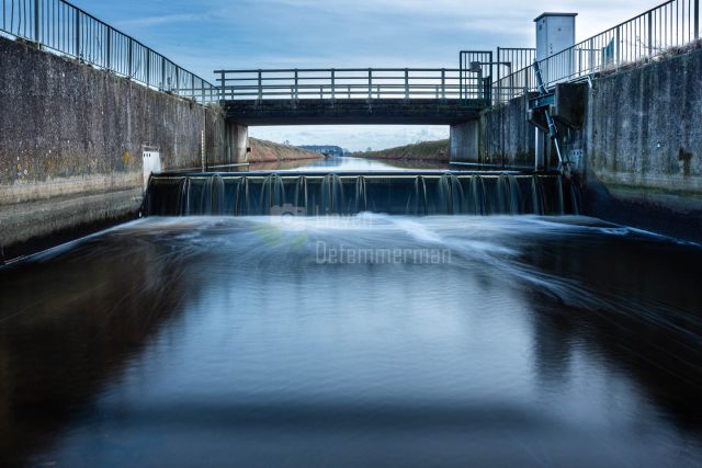 A weir regulates the water levels at the Isabellawatergang and the polders in Assenede, Flanders, Belgium