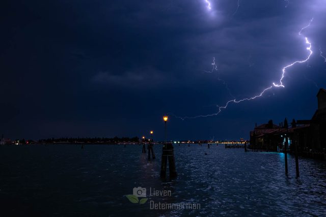 A lightning storm introducing heavy weather illuminates the bay of Venice, Italy