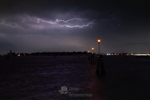 A lightning storm introducing heavy weather illuminates the bay of Venice, Italy