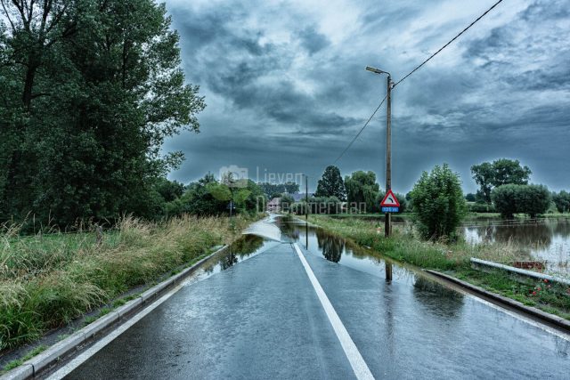 An empty street in Galmaarden is flooded by the river De Mark at Tollembeek, Galmaarden, Flanders, Belgium