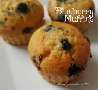 White plate with three blueberry muffins.