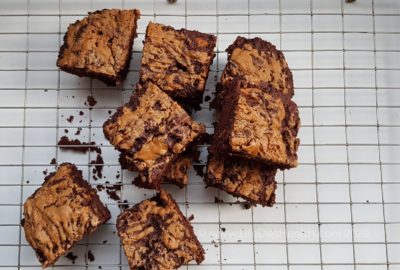 Biscoff brownie squares on a wire baking rack