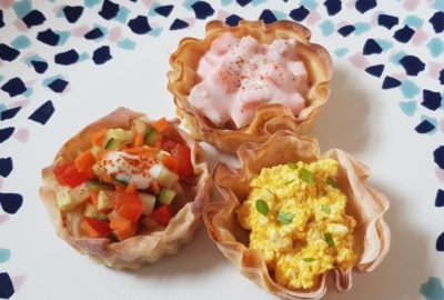 Three vol au vents on a plate with various vegan fillings
