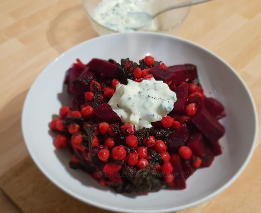 Bowl of beetroot curry with raita