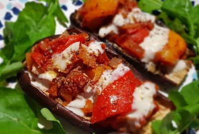 Stuffed aubergines on a bed of rocket with yogurt drizzle