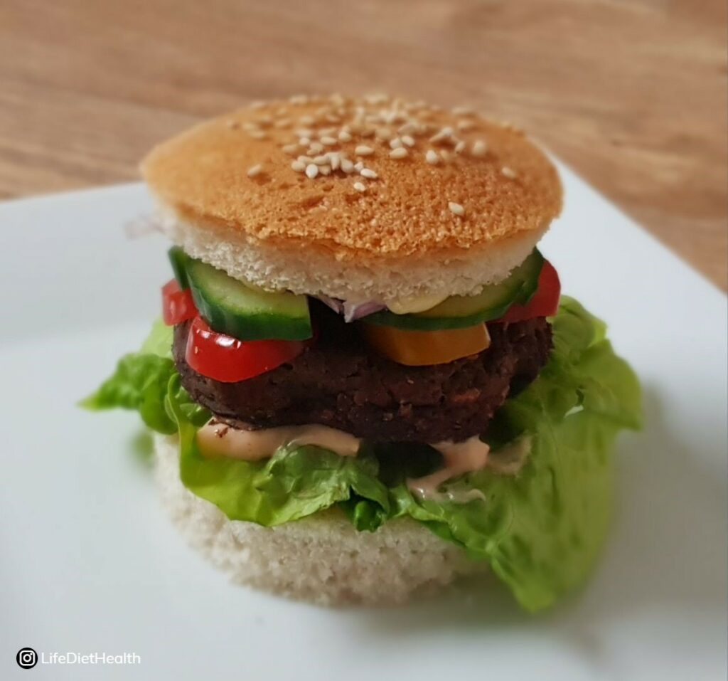 burger in a bun on a white plate