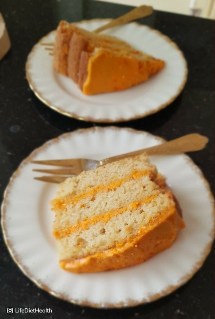 three layers of sponge cake with orange icing