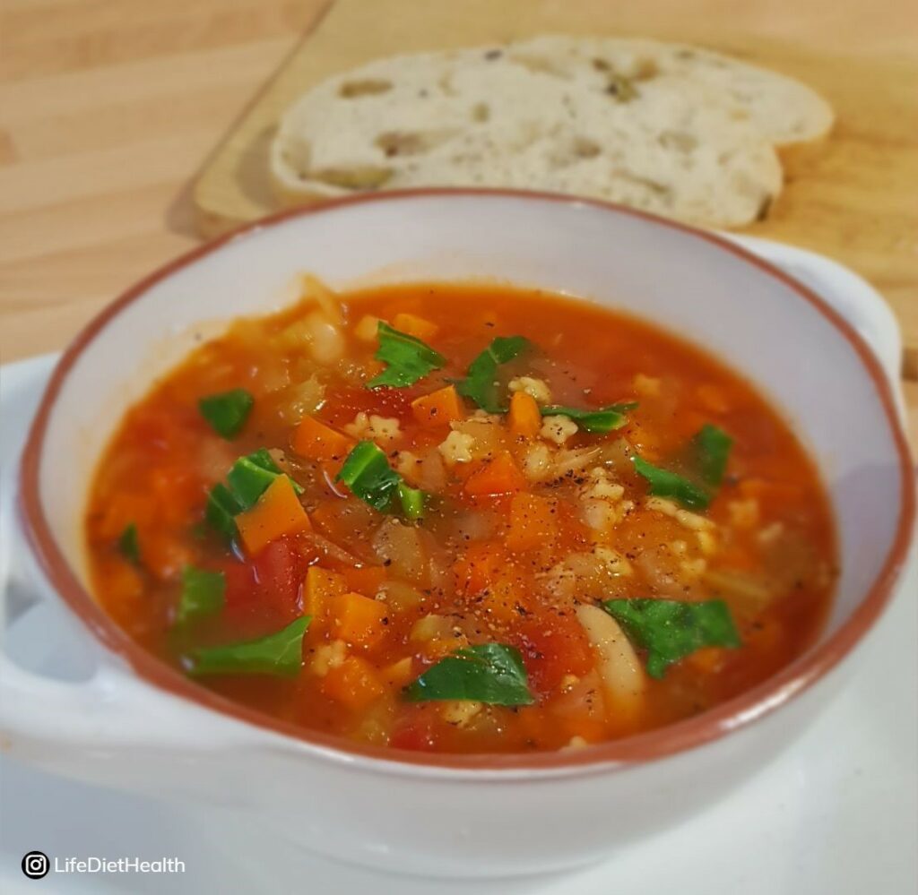 bowl of minestrone with bread