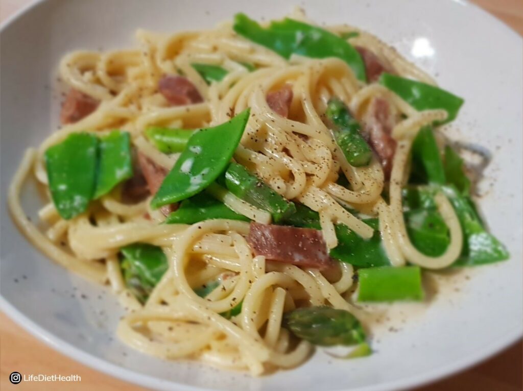 close up of veggie carbonara in a white bowl