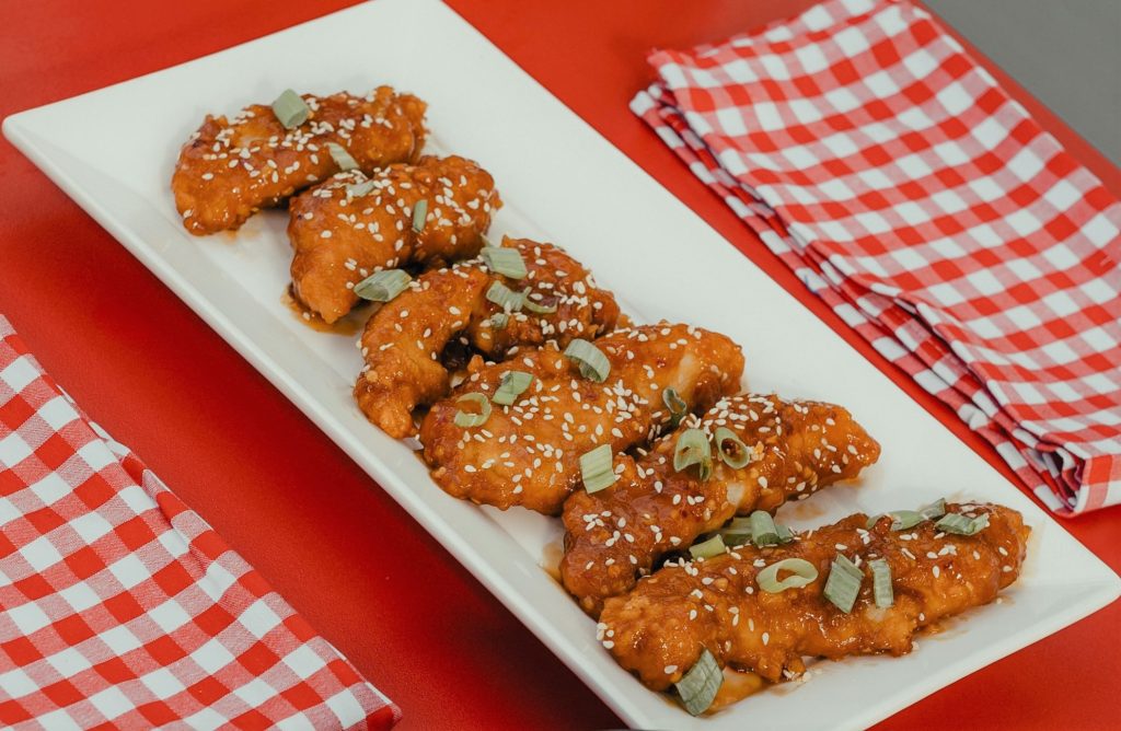 chicken strips on a plate with sesame seeds
