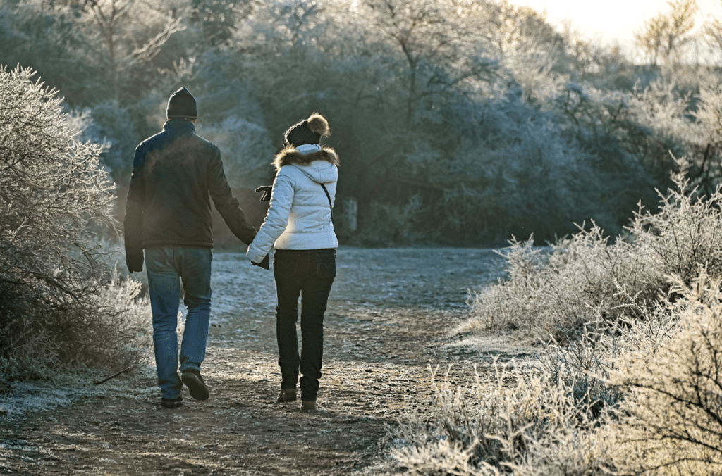 couple taking a walk through frosted nature