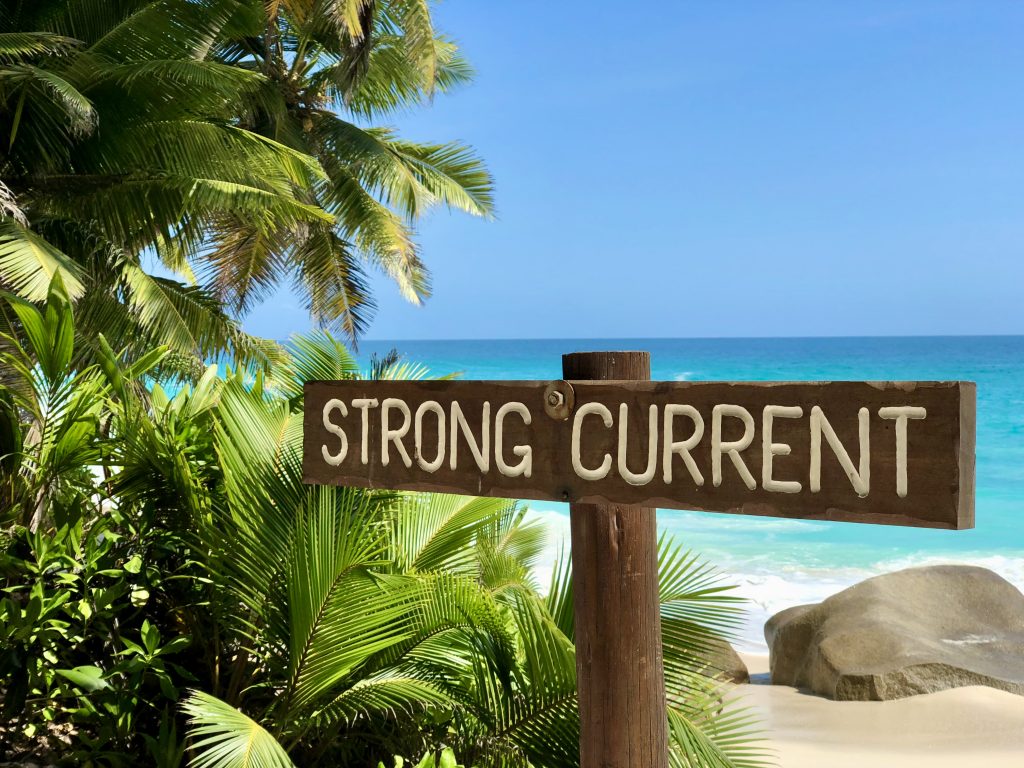 A beach sign warning "Strong currents" on Anse Victorin beach on Fregate Island. Photo by Mihaela Limberea