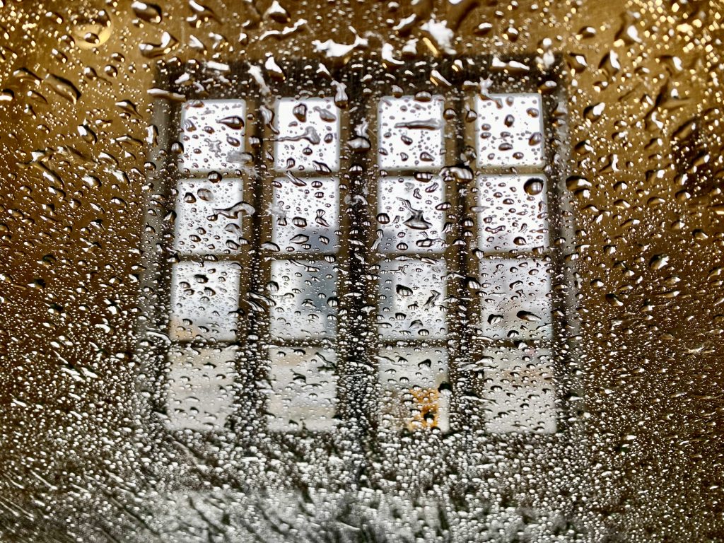 A window seen from the interior of the car when the car is in the car wash. Phone photo by Mihaela Limberea.