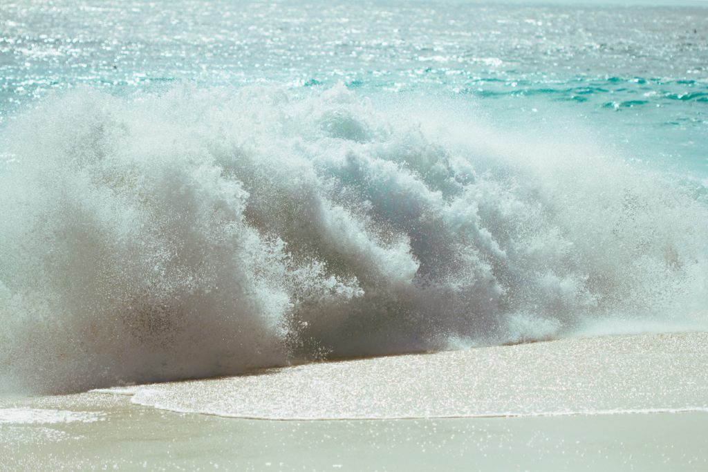 Waves crashing on the beach. Photo by Mihaela Limberea