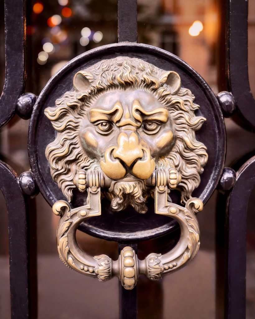 Door detail in Paris, showing a lion head