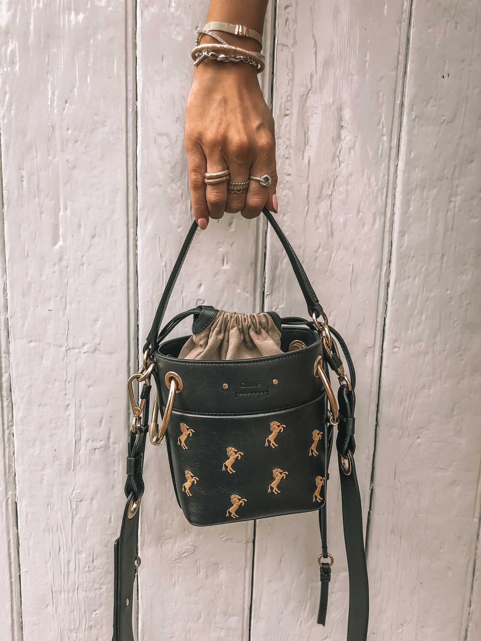 Navy Chloe Roy Mini Bucket Bag with yellow embroidered horses & lots of pandora stacking rings!