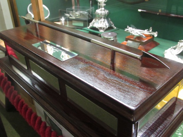 Picture of a silver arrow in a display cabinet.