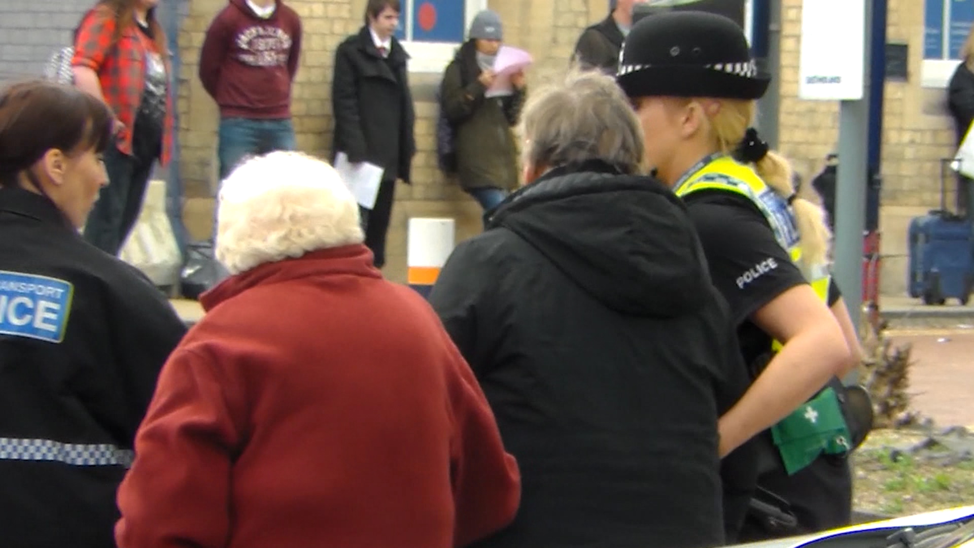 Evacuated: A police officer helps members of the public at the scene of the gas leak.