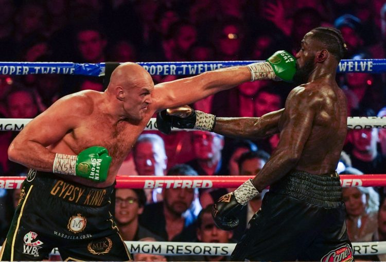 Tyson Fury punching Deontay Wilder in the head