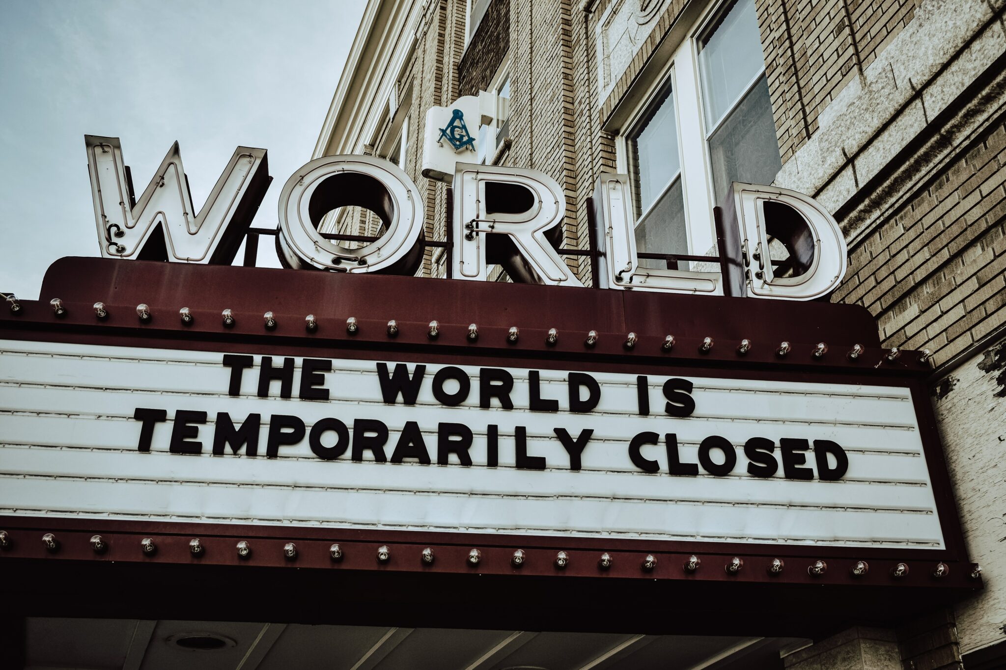 The World is Temporarily Closed letters in Brown colour
